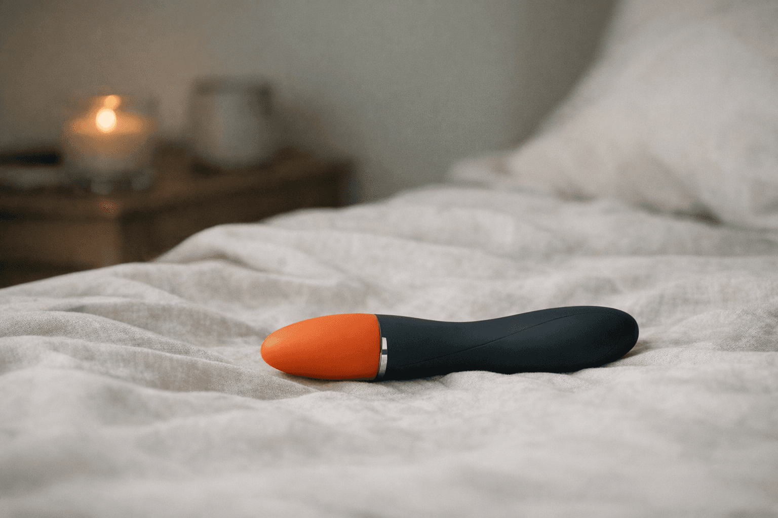 Stylish vibrator on a soft fabric surface