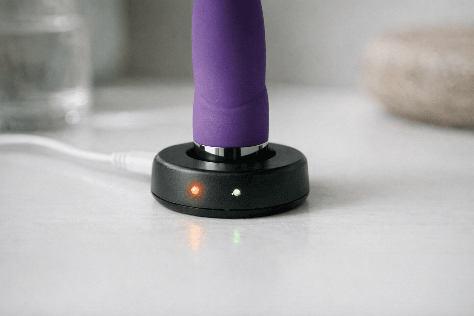 A plusOne Vibrator Charger on a surface