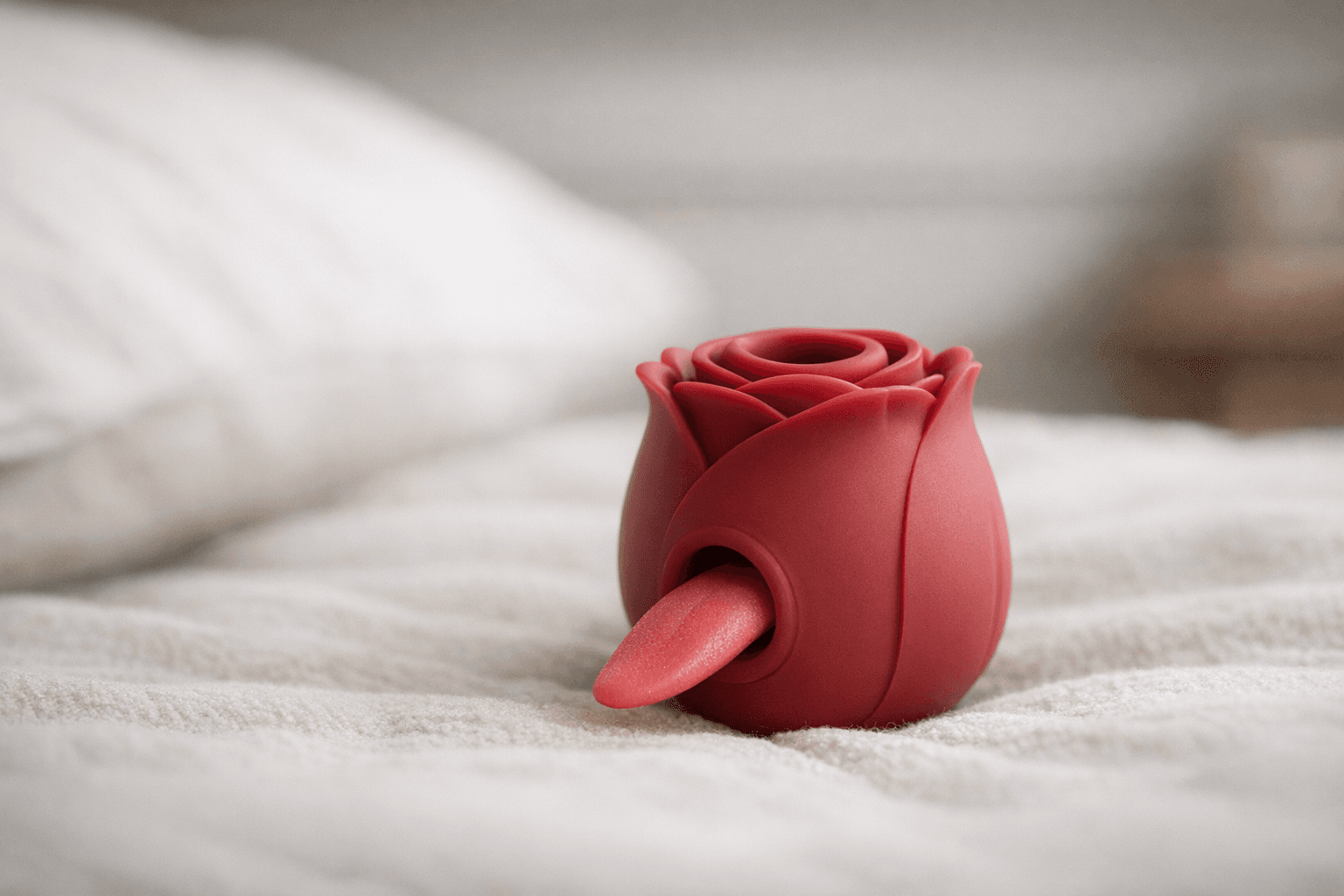 Rose toy with tongue on a soft surface