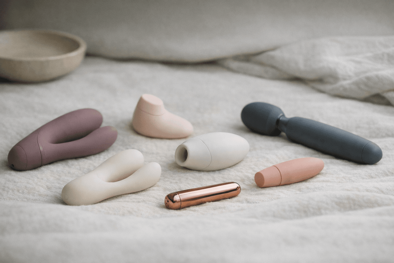 A collection of quiet vibrators showcased on a soft surface.